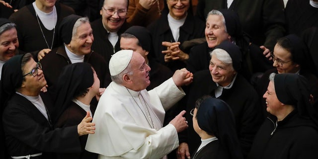 Pope Francis greets a group of nuns during his weekly general audience, in Paul VI Hall at the Vatican on Wednesday. Francis has appointed Francesca Di Giovanni as the undersecretary of multilateral affairs in one of the Vatican's most powerful offices. (AP Photo/Alessandra Tarantino)