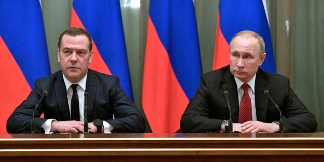 Russian President Vladimir Putin, right, and Russian Prime Minister Dmitry Medvedev attend a cabinet meeting in Moscow, Jan. 15, 2020. 