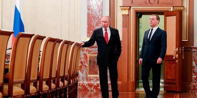 Russian President Vladimir Putin, right, and Russian Prime Minister Dmitry Medvedev before a cabinet meeting in Moscow on Wednesday. (Dmitry Astakhov, Sputnik, Government Pool Photo via AP)