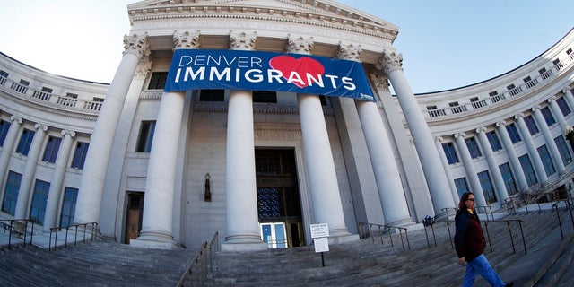 In this Feb. 26, 2018 file photo, a banner to welcome immigrants is viewed through a fisheye lens over the main entrance to the Denver City and County Building. U.S. Immigration and Customs Enforcement has subpoenaed Denver law enforcement for information on four foreign nationals wanted for deportation and could expand the unusual practice to other cities, an escalation of the conflict between federal officials and so-called sanctuary cities. (AP Photo/David Zalubowski, File)