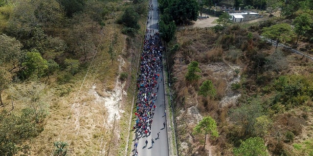 Migrants walk along a highway in hopes of reaching the distant United States, near Agua Caliente, Guatemala, in January 2020. (AP)