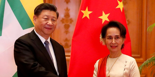 Myanmar State Counselor Aung San Suu Kyi, right, greets Chinese President Xi Jinping at president house in Naypyitaw, Myanmar, Saturday, Jan. 18, 2020. (Associated Press)