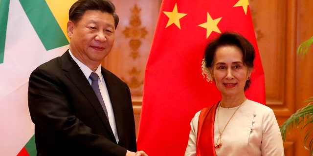 Myanmar State Counselor Aung San Suu Kyi, right, greets Chinese President Xi Jinping at president house in Naypyitaw, Myanmar, Saturday, Jan. 18, 2020. (Associated Press)