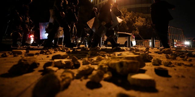 Lebanese police walk after dispersing a protest in Beirut, Lebanon, Saturday, Jan. 18, 2020. 