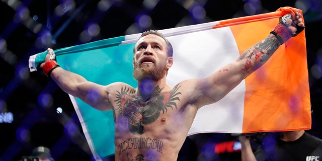 Conor McGregor celebrates after defeating Donald 