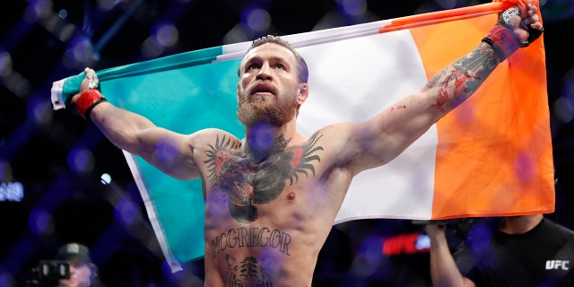 Conor McGregor celebrates after defeating Donald 