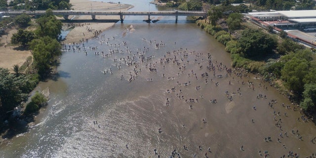 Central American migrants cross the Suchiate River by foot from Tecun Uman, Guatemala. (AP Photo/Santiago Billy)