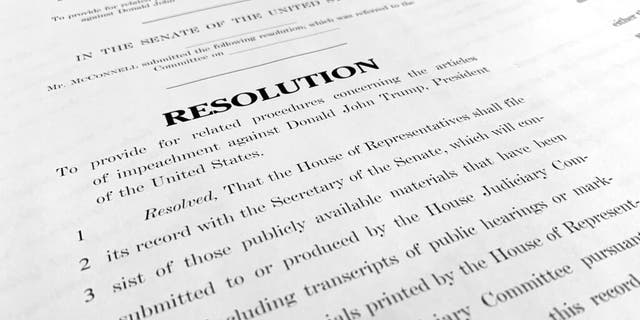 A copy of a Senate draft resolution to be offered by Senate Majority Leader Mitch McConnell, R-Ky., regarding the procedures during the impeachment trial of President Trump. (AP Photo/Jon Elswick)