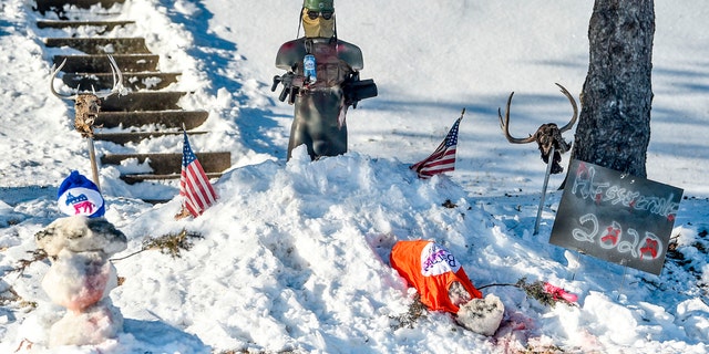 A snow display in the yard of Donald Hesseltine is seen Monday, Jan. 20, 2020, in Davenport, Iowa. Leaders in the city condemned Hesseltine's display, depicting a figure gunning down a snowman wearing a Bernie Sanders shirt and another adorned with a Democratic Party hat. (Meg McLaughlin/Quad City Times via AP)