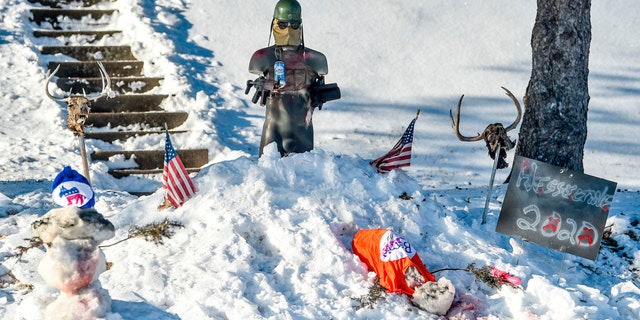 A snow display in the yard of Donald Hesseltine is seen Monday, Jan. 20, 2020, in Davenport, Iowa. Leaders in the city condemned Hesseltine's display, depicting a figure gunning down a snowman wearing a Bernie Sanders shirt and another adorned with a Democratic Party hat. (Meg McLaughlin/Quad City Times via AP)