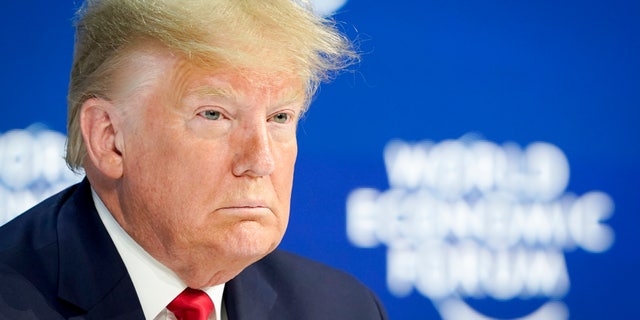 US President Donald Trump waits on stage before addressing a plenary session of the World Economic Forum in Davos, Switzerland, Tuesday, Jan. 21, 2020. (Gian Ehrenzeller/Keystone via AP)