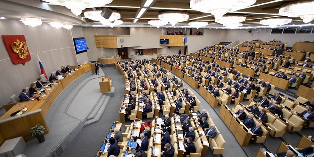 Russian lawmakers work during a session at the Russian State Duma, the Lower House of the Russian Parliament in Moscow, Russia, on Tuesday. (AP Photo/Alexander Zemlianichenko)
