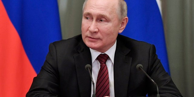 Russian President Vladimir Putin attends a new cabinet meeting in Moscow on Tuesday. Putin formed his new Cabinet Tuesday, replacing many of its members but keeping his foreign, defense and finance ministers in place. (Alexei Nikolsky, Sputnik, Kremlin Pool Photo via AP)