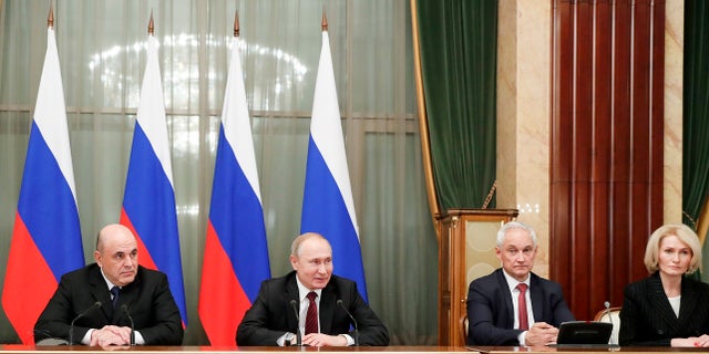 Russian President Vladimir Putin, second left, new Russian Prime Minister Mikhail Mishustin, left, former Putin's economic adviser Andrei Belousov, appointed as a first deputy Prime Minister, second right, and deputy Prime Minister Viktoria Abramchenko attend a new cabinet meeting in Moscow on Tuesday. Putin formed his new Cabinet Tuesday, replacing many of its members but keeping his foreign, defense and finance ministers in place. (Dmitry Astakhov, Sputnik, Government Pool Photo via AP)