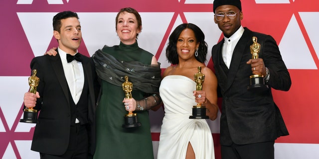 FILE - This Feb. 24, 2019 file photo shows Oscar winners, from left, Rami Malek, for best performance by an actor in a leading role for "Bohemian Rhapsody", Olivia Colman, for best performance by an actress in a leading role for "The Favourite", Regina King, for best performance by an actress in a supporting role for "If Beale Street Could Talk", and Mahershala Ali, for best performance by an actor in a supporting role for "Green Book", holding their awards in the press room at the Oscars in Los Angeles. The four will present awards during the Feb. 9 ceremony.