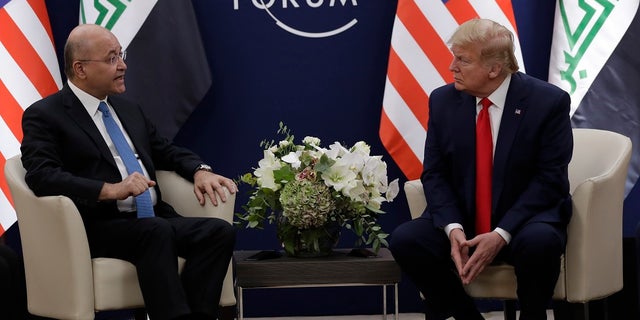 US President Donald Trump, right, attends a meeting with his Iraqi counterpart Barham Salih at the World Economic Forum in Davos, Switzerland on Wednesday. Trump's two-day stay in Davos is a test of his ability to balance anger over being impeached with a desire to project leadership on the world stage. (AP Photo/Evan Vucci)