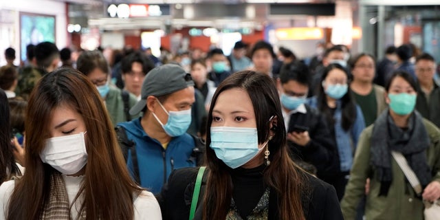 Passengers wear masks to prevent an outbreak of a new coronavirus in a subway station, in Hong Kong, Wednesday, Jan. 22, 2020.(AP Photo/Kin Cheung)