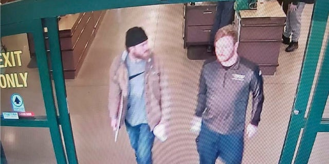 This image from a Jan. 1, 2020, surveillance video and released in a U.S. attorney detention memorandum, shows Brian Mark Lemley Jr, right, and Patrik Mathews leaving a store in Delaware where they purchased ammunition and paper shooting targets. The pair, along with William Garfield Bilbrough IV, plotted to carry out “essentially a paramilitary strike” at a Virginia gun rights rally, a federal prosecutor said Wednesday. (U.S. Attorney via AP)