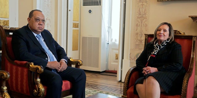 Angolan attorney general Helder Pitta Gros meets with his Portuguese counterpart Lucilia Gago, right, at the Portuguese attorney general's office in Lisbon on Thursday. Angola's attorney general arrived Thursday in Portugal to ask for help investigating a major corruption case targeting Isabel dos Santos, the billionaire daughter of Angola's former longtime leader. (AP Photo/Armando Franca)