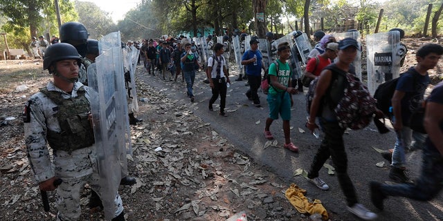 Mexican National Guards detain migrants near Tapachula, Mexico on Thursday. (AP Photo/Marco Ugarte)