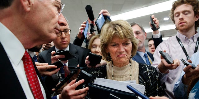 Sen. Lisa Murkowski, R-Alaska, center, and Sen. John Barrasso, R-Wyo., react to the final statement of House Democratic impeachment manager Rep. Adam Schiff, D-Calif., as they speak to the media at the end of a day of an impeachment trial of President Donald Trump on charges of abuse of power and obstruction of Congress, Friday, Jan. 24, 2020, on Capitol Hill in Washington. (Associated Press)