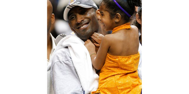 Kobe Bryant holding his daughter Gianna after the Lakers defeated the Magic 99-86 to win the NBA Finals in 2009. (AP Photo/David J. Phillip, File)