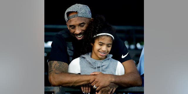 Kobe Bryant and his daughter Gianna at the U.S. national championships swimming meet in Irvine, Calif., in July 2018. (AP Photo/Chris Carlson, File)