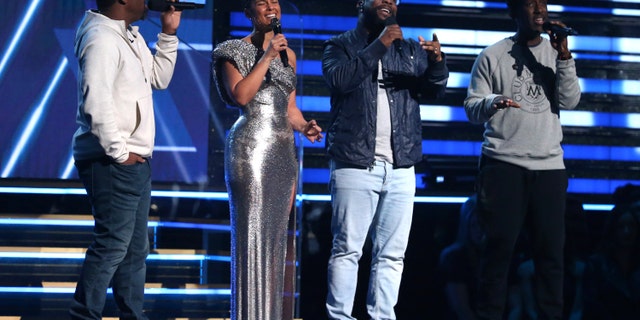 Nathan Morris, from left, Wanya Morris, Shawn Stockman, of Boyz II Men, and Alicia Keys, second left, sing a tribute in honor of the late Kobe Bryant at the 62nd annual Grammy Awards on Sunday.