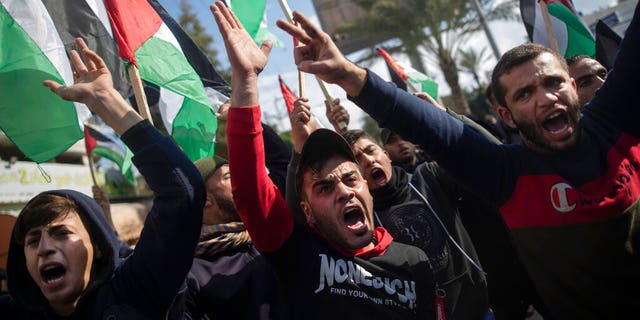 Palestinian protesters chant angry slogans during a protest against the U.S. Mideast peace plan, in Gaza City, Monday, Jan. 28, 2020. 