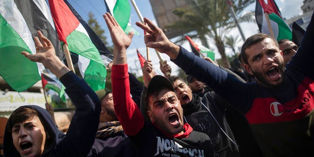 Palestinian protesters chant angry slogans during a protest against the U.S. Mideast peace plan, in Gaza City, Monday, Jan. 28, 2020.