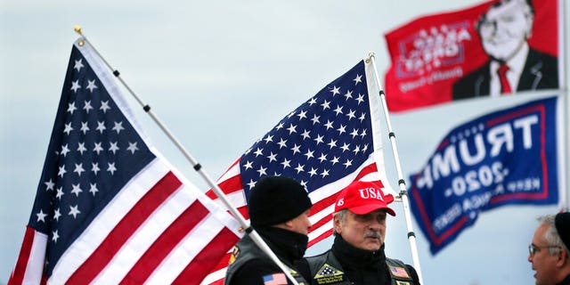 President Donald Trump supporters John Walker, left, and Mike Kufta stand on the Wildwood boardwalk as they wait to attend a campaign rally with Trump, Tuesday, Jan. 28, 2020, in Wildwood, N.J. (AP Photo/Mel Evans)