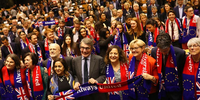 European Parliament President David Sassoli, center, stands with other British MEP's and members of the political group Socialist and Democrats as they participate in a ceremony prior to the vote on the UK's withdrawal from the EU at the European Parliament in Brussels, Wednesday, Jan. 29, 2020.