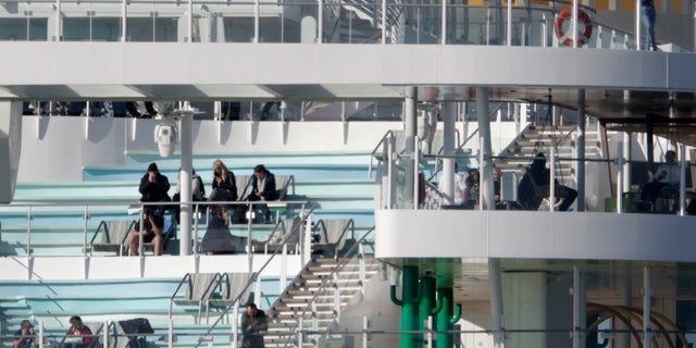 Italian health authorities are screening passengers aboard after a passenger from Macao came down with flu-like symptoms amid the global scare about a new virus. (AP Photo/Andrew Medichini)