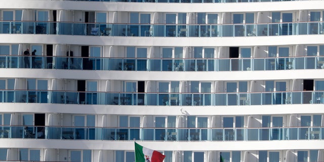 Passengers wait aboard the Costa Smeralda cruise ship, docked in the Civitavecchia port near Rome. (AP Photo/Andrew Medichini)