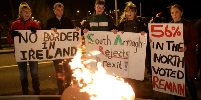 Protesters from the campaign group Border Communities Against Brexit take part in a demonstration in Carrickcarnon on the Irish border, Ireland on Friday. (AP Photo/Peter Morrison)