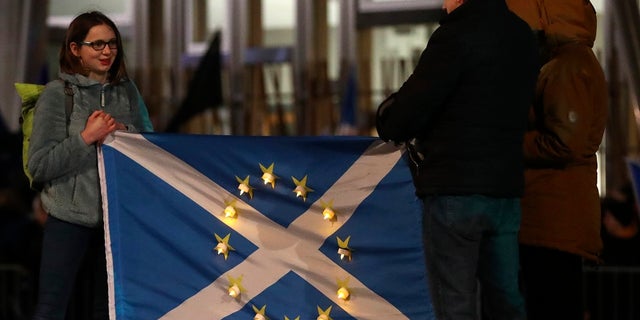 Anti-Brexit protesters gather outside the Scottish parliament in Edinburgh.<br>
Britain officially leaves the European Union on Friday after a debilitating political period that has bitterly divided the nation since the 2016 Brexit referendum. (AP Photo/Scott Heppell)