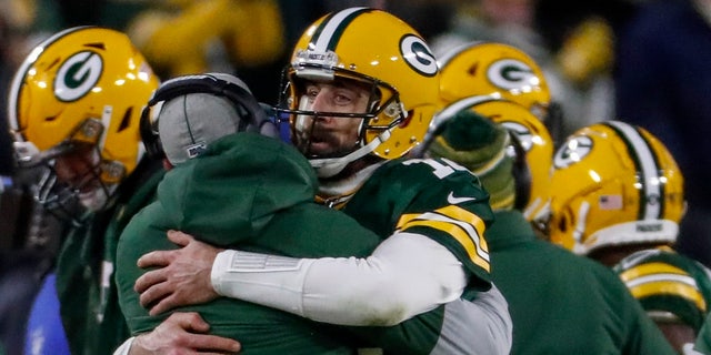 Green Bay Packers head coach Matt LaFleur celebrates a touchdown with Aaron Rodgers during the second half of an NFL divisional playoff football game against the Seattle Seahawks Sunday, Jan. 12, 2020, in Green Bay, Wis. (AP Photo/Matt Ludtke)