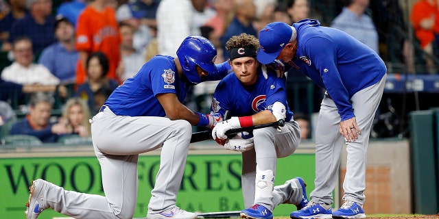 Albert Almora Jr. #5 of the Chicago Cubs is comforted by manager Joe Maddon #70 and Jason Heyward #22 after a young child was injured on foul ball off his bat in the fourth inning against the Houston Astros at Minute Maid Park on May 29, 2019 in Houston, Texas. (Photo by Bob Levey/Getty Images)