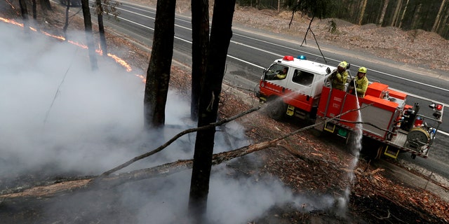 Firefighters manage a controlled burn to help contain a larger fire near Falls Creek, Australia, Sunday, Jan. 5, 2020.