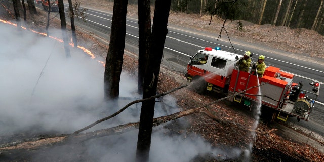 Firefighters manage a controlled burn to help contain a larger fire near Falls Creek, Australia, Sunday, Jan. 5, 2020.