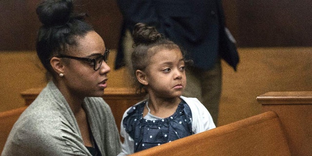 Shaynna Jenkins and her daughter Avielle at a court appearance for Aaron Hernandez in 2017.