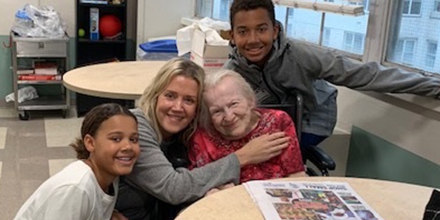 Basti Williams and his family visit with Hildegard, who has become part of their family.