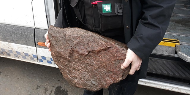 The "heavy rock" that was tied to Bella that authorities found after the dog was rescued on Monday.