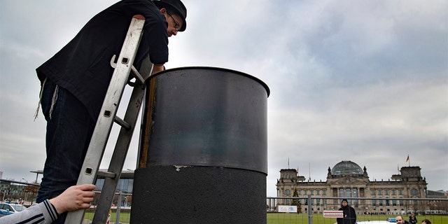 Several activists have tried to dismantle the controversial steel column in Berlin. (Paul Zinken/dpa via AP)