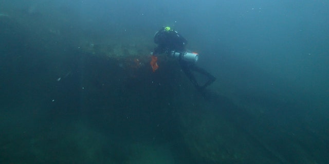 Diver Joe Citelli inspecting the SS Cotopaxi shipwreck.