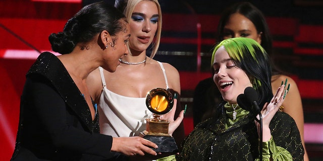 Alicia Keys, from left, and Dua Lipa present Billie Eilish with the award for best new artist at the 62nd annual Grammy Awards on Sunday, Jan. 26, 2020, in Los Angeles. (Photo by Matt Sayles/Invision/AP)