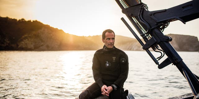 Borja Saracho, the owner of Crusoe Treasure, sits in his boat Capitania Maritima.