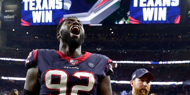 Houston Texans nose tackle Brandon Dunn (92) celebrating after the NFL wild-card playoff football game against the Buffalo Bills on Saturday. (AP Photo/Michael Wyke)