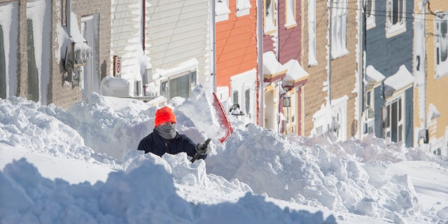 A resident digs out his walkway in St. John's Newfoundland on Saturday, Jan. 18, 2020.