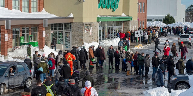 Customers line up at a Sobeys grocery store in St. John's, Newfoundland, Tuesday, Jan. 21, 2020.
